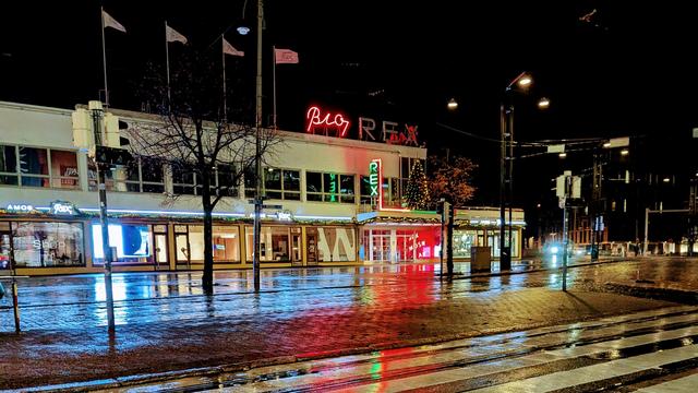 Night picture of biorex venue in rain. The name "biorex" is illuminated in neon colors