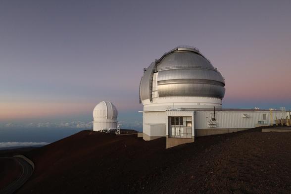 The Canada–France–Hawaii and Gemini North telescopes during “lilac hour” after sunset at the summit of Mauna Kea.