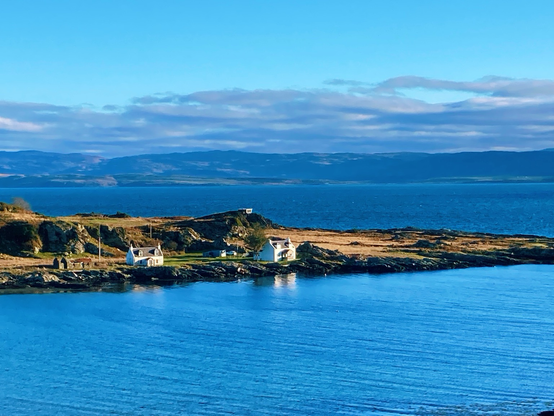 Deep blue seas around a promontory with white houses on it