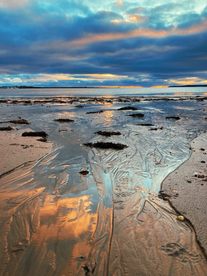 Water running over sand into the sea