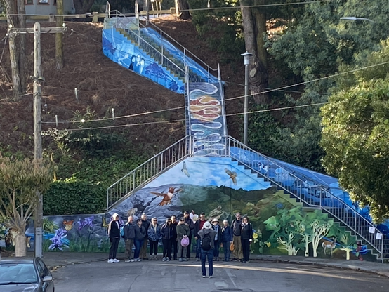 Caught a walking group photo shoot in progress at the Burnside Mural in Glen Park.  Photo shows group posing in front of the mural and tiled stairway