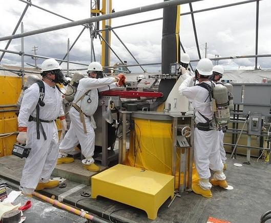 Hanford workers remove a failed pump from one of the Hanford nuclear site’s underground tanks storing 56 million gallons of a mix of radioactive and other chemical waste from the past production of plutonium. Courtesy Department of Energy