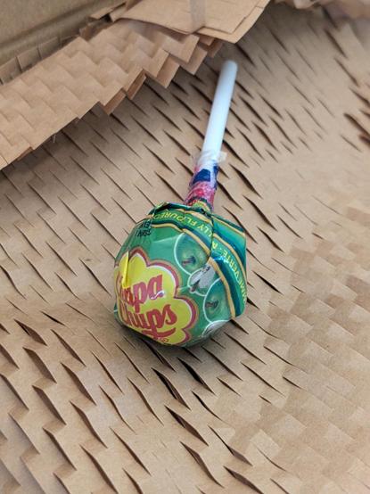 a "chupa chups" brand green apple lollipop