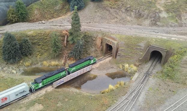A pair of Burlington Northern locomotives enters a tunnel below track taking trains from the outer (red) line to the inner (blue) line on our N-Trak layout.