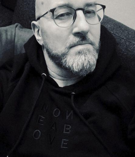 Daniel Myer looking mysterious. wearing black dustrial hoodie