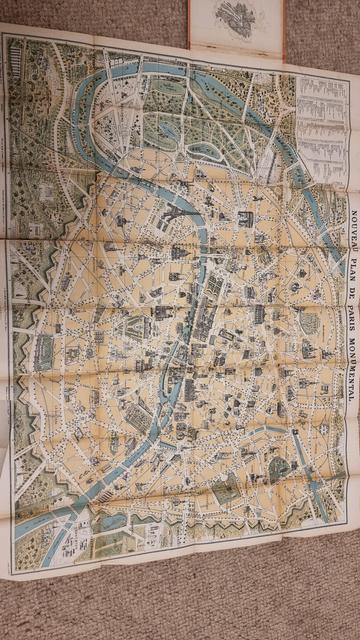 An old map of Paris, in muted greens and browns. with lots of creases in the paper.