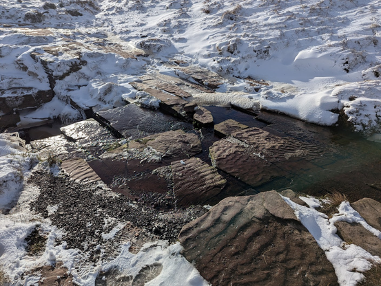 A close up of one of the streams with the square shaped rocks showing the stippled effect of having been a beach at one point.