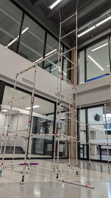 A tall PVC structure consisting connected of 20x20-inch gates.