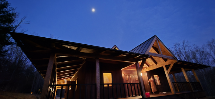The sala of Forest Dhamma Monastery at dawn with the moon overhead.