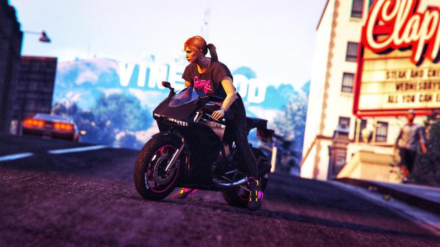 A screenshot I took in the video game GTA Online using the Rockstar Editor. It shows my female character on a Nagasaki Carbon RS in front of the Vinewood sign.