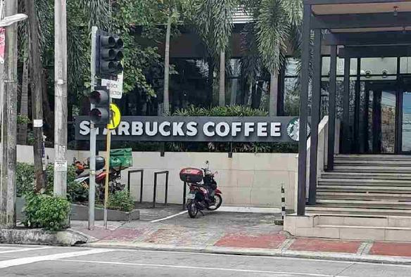 Partial screenshot of a photo from Google Maps info on a Starbucks store. It shows the storefront with some bike racks at road level, but the floor level of the store is much higher and the bike parking cannot be seen from inside the store.