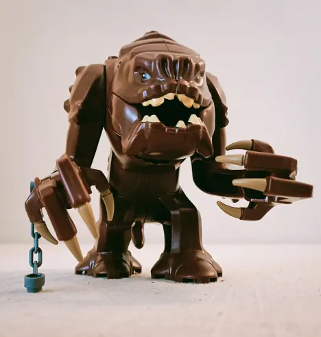 A Lego Rancor Monster, yesterday. This is based on the very first appearance way back in 1983's Return of the Jedi. It is brown skinned, like living poop, with big chunky white teeth. It also comes with a piece of chain attached to a loop on its wrist. Rancor are actually very gentle creatures and only eat people when it's deemed really funny.