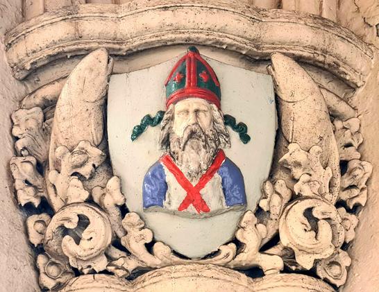 A sculptural carving of a bishop with a striking resemblance to the Glaswegian commedian Billy Connolly.