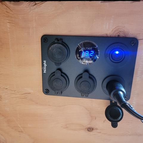 Panel with voltage readout and blue glowing switch