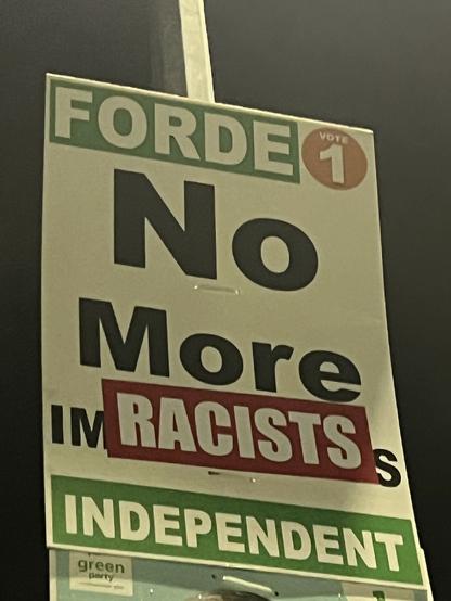 An election poster, that originally said “No more immigrants” with a sticker that changed the text to "No More RACISTS”.