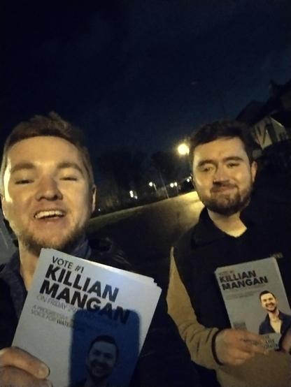 A selfie of Killian and his cousin John holding leaflets.