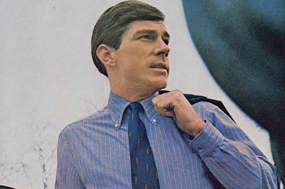 1967 Unidentified Man in Striped Shirt and Tie

This image depicts a man, seemingly from an older photograph given the grainy texture.
He is dressed formally with a striped shirt paired with a dark-colored tie that has gold accents.