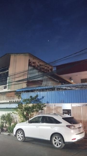 A picture of the night sky above a street in Phnom Penh, Cambodia. There is one very bright point visible in the sky.