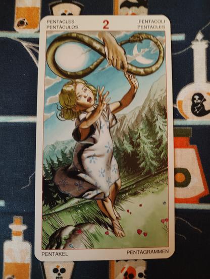 Card from the Initiatory Tarot of the Golden Dawn deck published by Lo Scarabeo.
Two of Pentacles. 
A young child, a girl, in simple light pink dress, blonde, reaching out. Just out of her reach is a hand from heaven holding a snake biting its own tail forming a lemniscate.