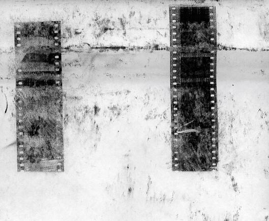 black and white image with a copy machine made copy with some 35mm films that is blurred and twisted