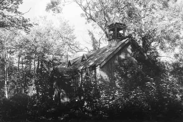 photo of tin chapel, overgrown in black and white