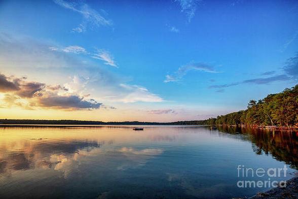 Glowing End of Day Light is a color photograph taken at sunset at Twin Lakes PA with beautiful reflections of clouds in the water.