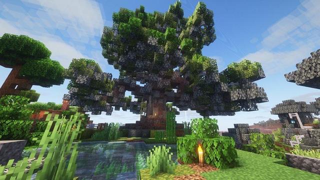 Different angle of the oak tree from underneath by a small custom pond.