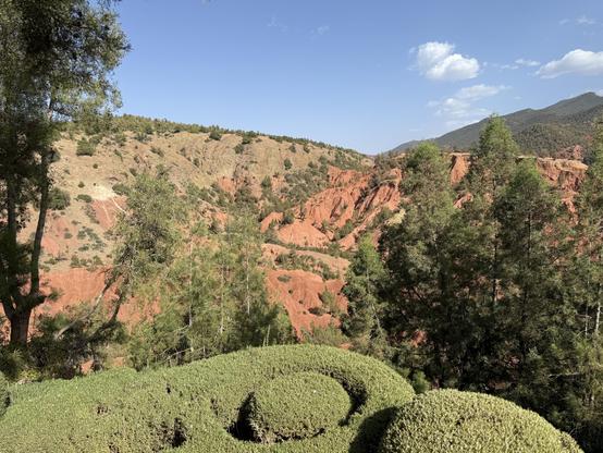 Deep clay-red mountainside…