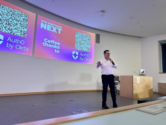 A man on stage at a tech event