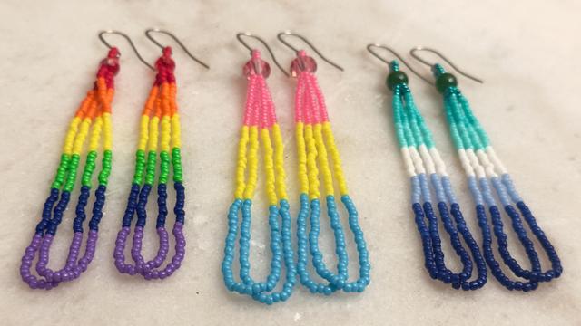 Three pairs of beaded loop earrings in pride flag colors--rainbow flag, pansexual pride flag, gay pride flag