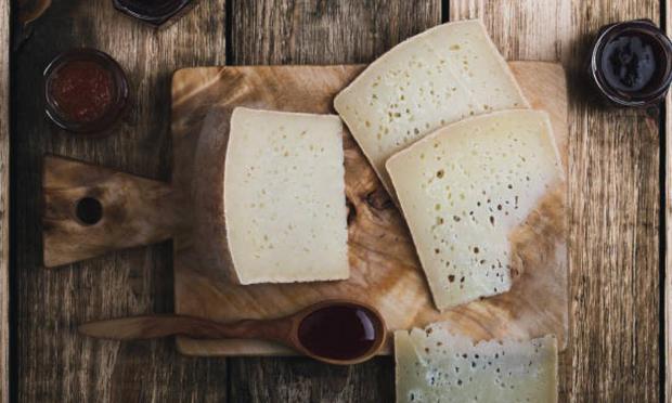 Queso pecorino cortado sobre una tabla rústica. (Getty Images)