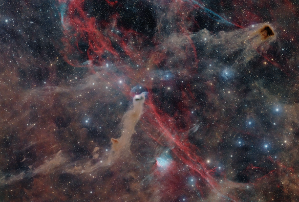 An astrophotograph of brown dust and red hydrogen