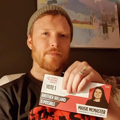 Denman holding a pamphlet with People Before Profit vote 1 and a picture of Galway West candidate Maisie McMaster