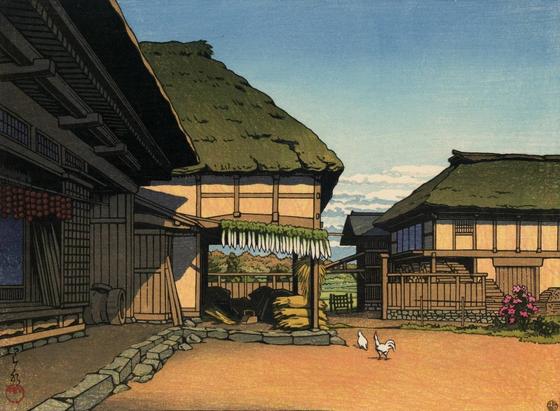 Afternoon sun warms a rural farm in autumn. A pair of thatched roof buildings box in a wide yard, where two white chickens scratch and peck the dirt. Persimmons and daikon are hung up on poles over entranceways, drying in the sun. On the right, stacks of firewood have been laid in for the coming cold weather. Between the buildings and beyond the yard, there is a glimpse of open fields and a line of trees, their leaves rusting brown with the season. A few clouds hug the horizon, but the sky above is clear and blue