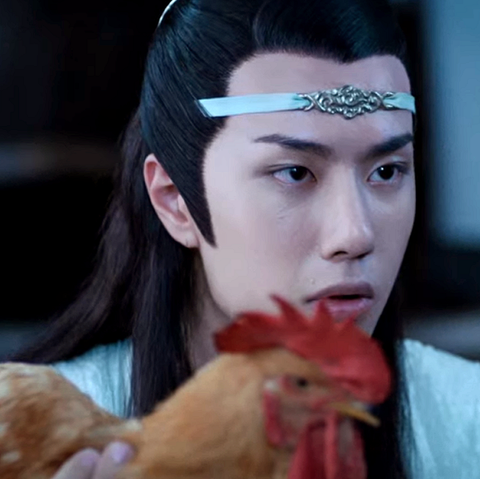 Wang Yibo as Lan Zhan, looking a bit drunk, holding up a chicken