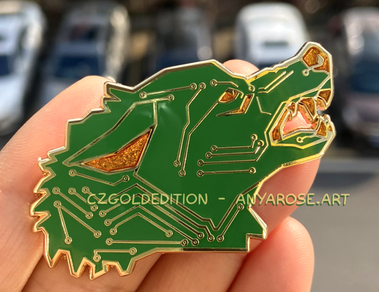 Hand holding up an enamel pin of a snarling wolf designed to look like a printed circuit board (PCB).