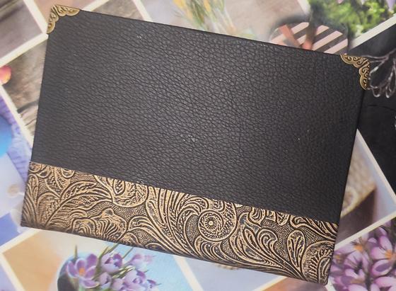an a6 single signature pamphlet, with black faux leather as cover, and on the side decorated copper color faux leather.