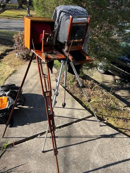 Two large format cameras, a 5x7 and an 8x10, setup on tripods on a walkway ready to shoot.