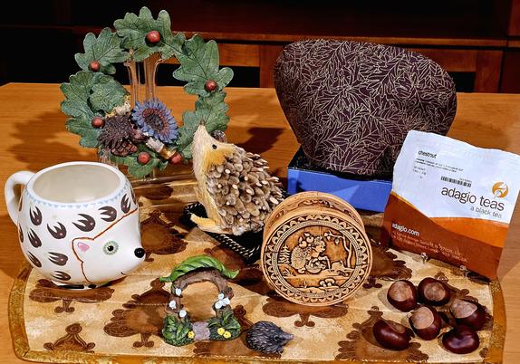 A tea tableau of a hedgehog in a forest crooning to a woodsprite of their impossible romance. The tea is Chestnut black tea from Adagio.