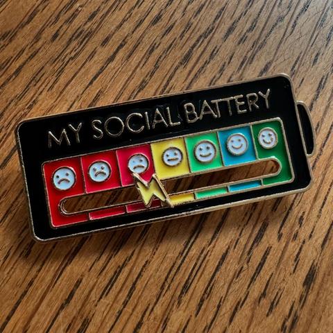 A rectangular badge with the words ‘Social Battery’ on, and a slider that you can adjust, which goes from Low (red/sadface emoji) to high (green/happyface) via 7 intermediate stages.