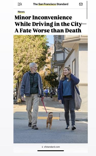 Accurate-looking San Francisco Standard screenshot with headline "Minor Inconvenience While Driving in the City - A Fate Worse than Death" above an image of two pedestrians and a small dog in a crosswalk.