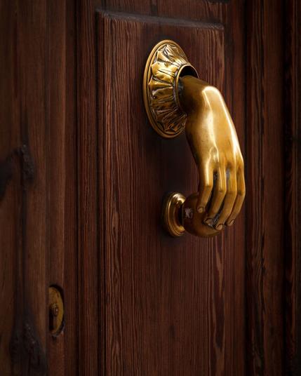 Hand shaped door knock