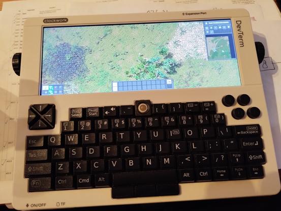 photo of the DevTerm running Factorio. it shows 34 FPS and 60 UPS.