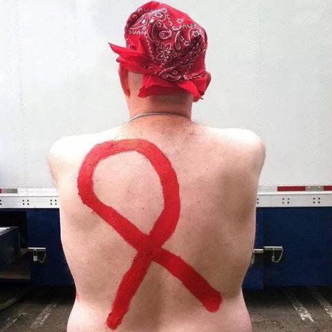 My back with an red AIDS ribbon painted on it