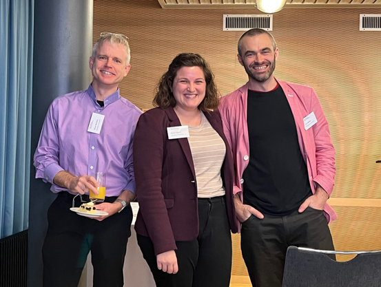 photo
three smiling people, all with pink or purple shirts or jackets