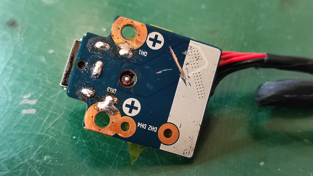 The underside of the same circuit board, showcasing soldered connections and mounting points.