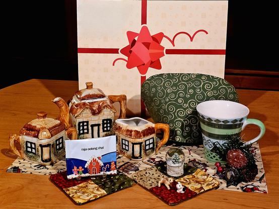 A Christmas tea tableau with a rustic cottage theme in warm tones of tan, berry, and green.