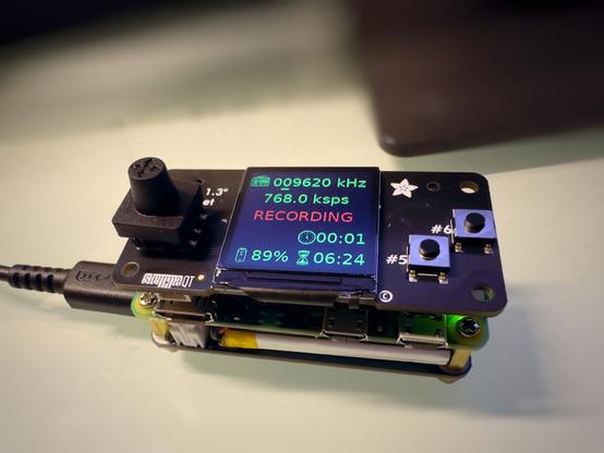 This image shows a Raspberry Pi Zero 2W with a LiPo battery powered UPS bottom HAT and a TFT screen + joystick + two button HAT attached on top. The screen is showing the UI described in the post.