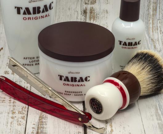 A beautiful Weck Sextoblade with red scales next to a Stank Tank® with matching brush, splash, and frag