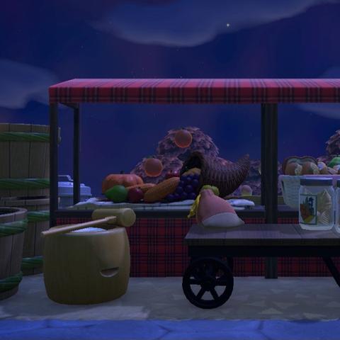 Animal Crossing: New Horizons screenshot. Image shows a small farmer's market with two booths showing new produce and a table in front with a purse / jarred bamboo shoots.